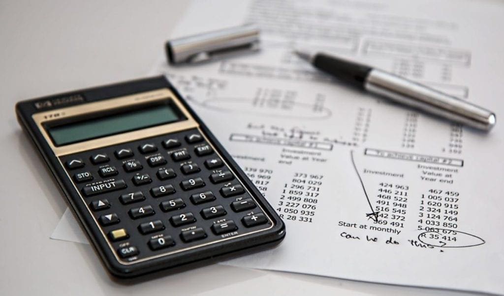 calculator with pen and financial calculations