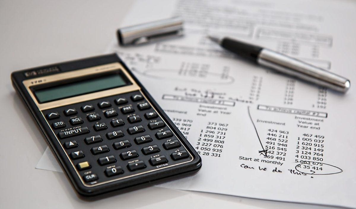 calculator with pen and financial calculations