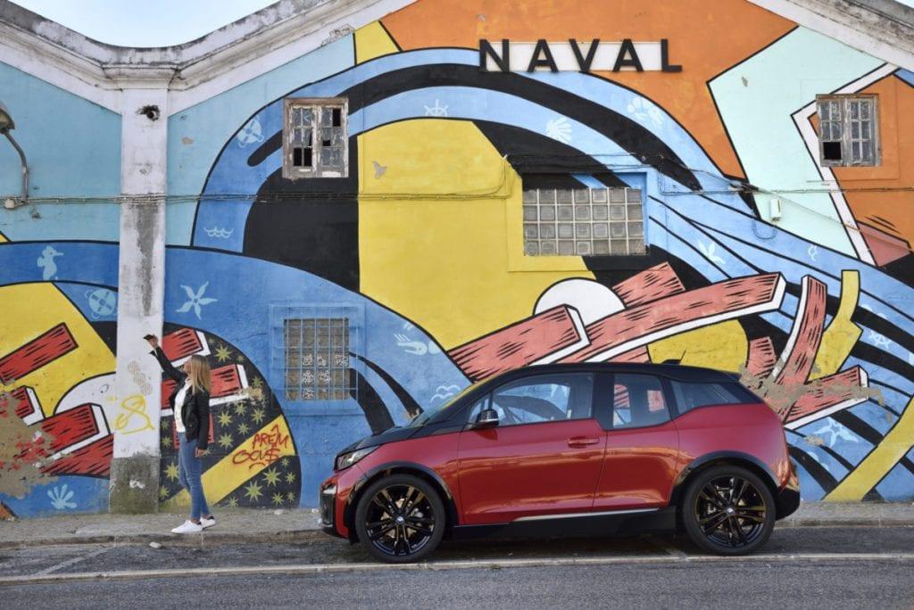 BMW i3s parked in front of mural