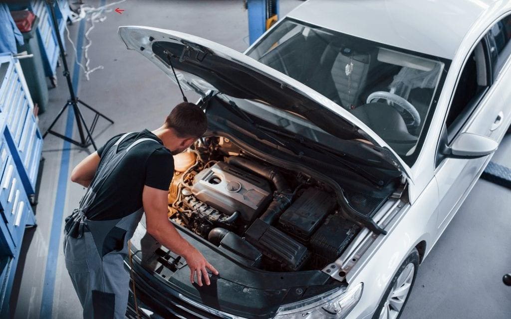 car mechanic under the hood