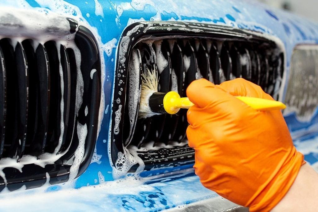 car detailer works on grille