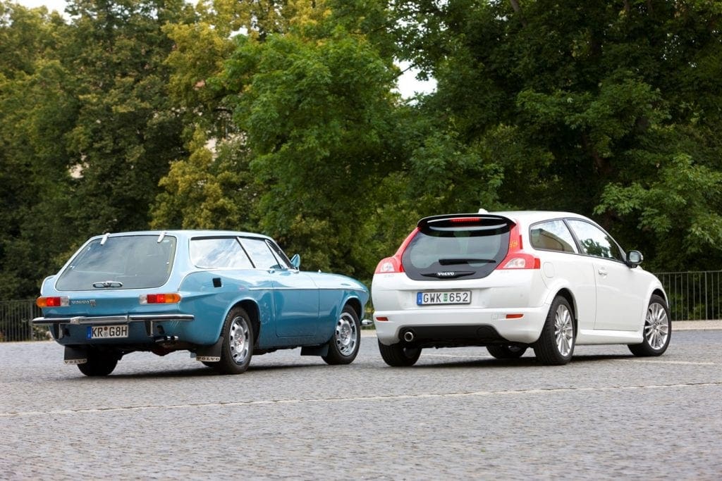 a Volvo P1800ES parked beside a Volvo C30
