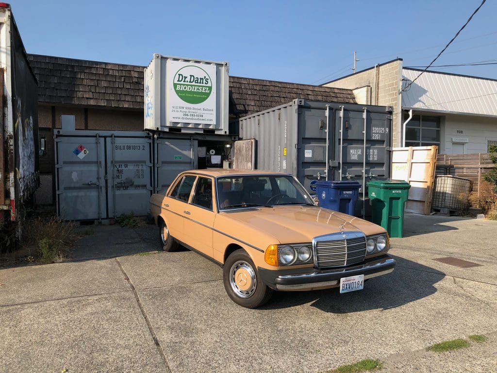 1977 Mercedes-Benz 240D parked in front of Dr. Dan's Biodiesel station