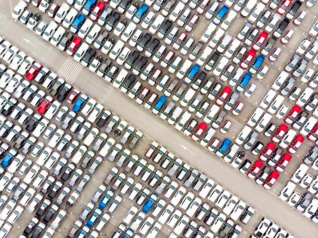 dozens of cars sitting in a lot
