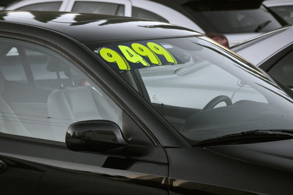 car with price tag in window