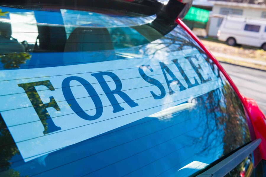 Car with for sale sign in rear window