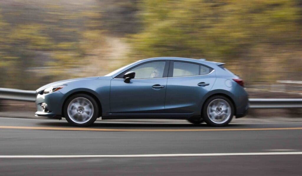 2015 Mazda 3 hatchback driving on the highway