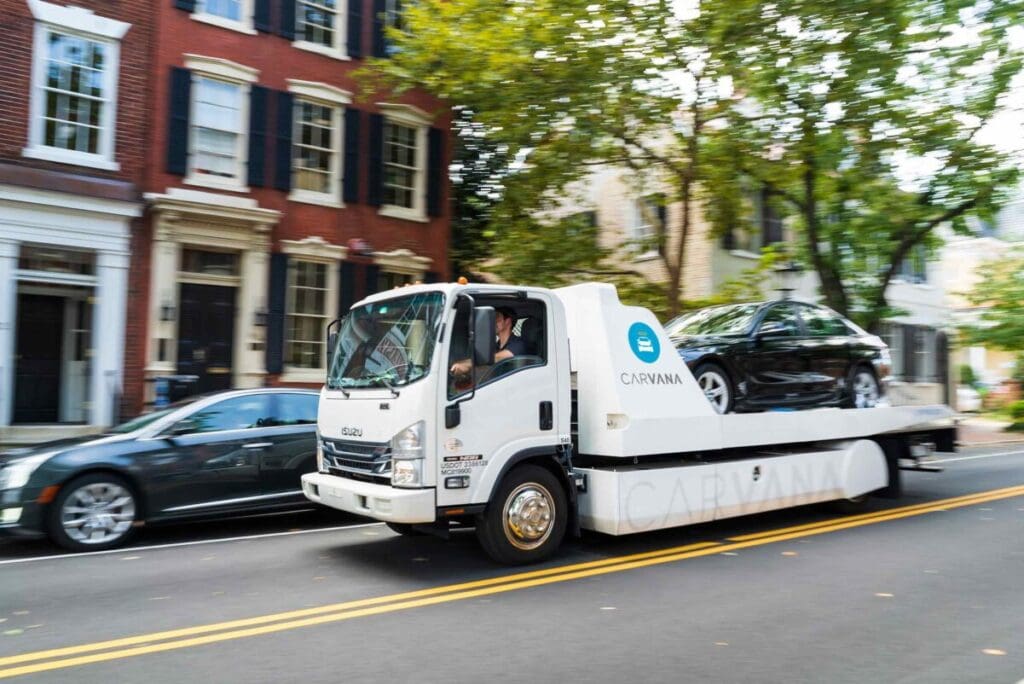 Carvana hauler driving through neighborhood