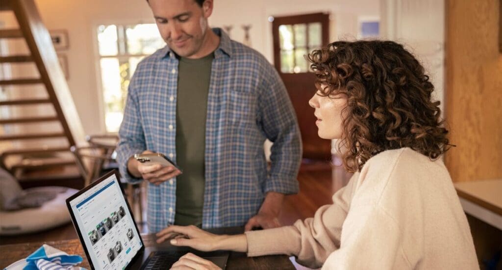 Couple using computer to shop for cars from home