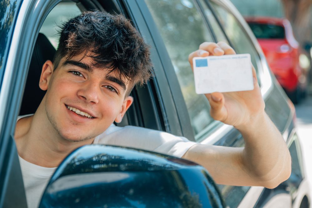 Teenager showing his new driver's license