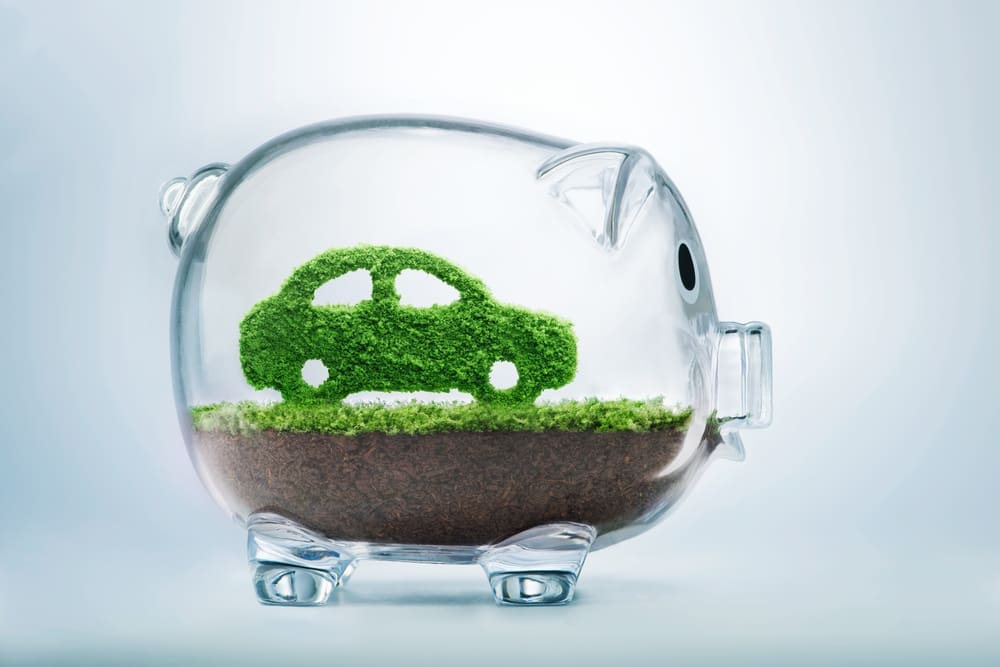 hybrid car inside glass piggy bank